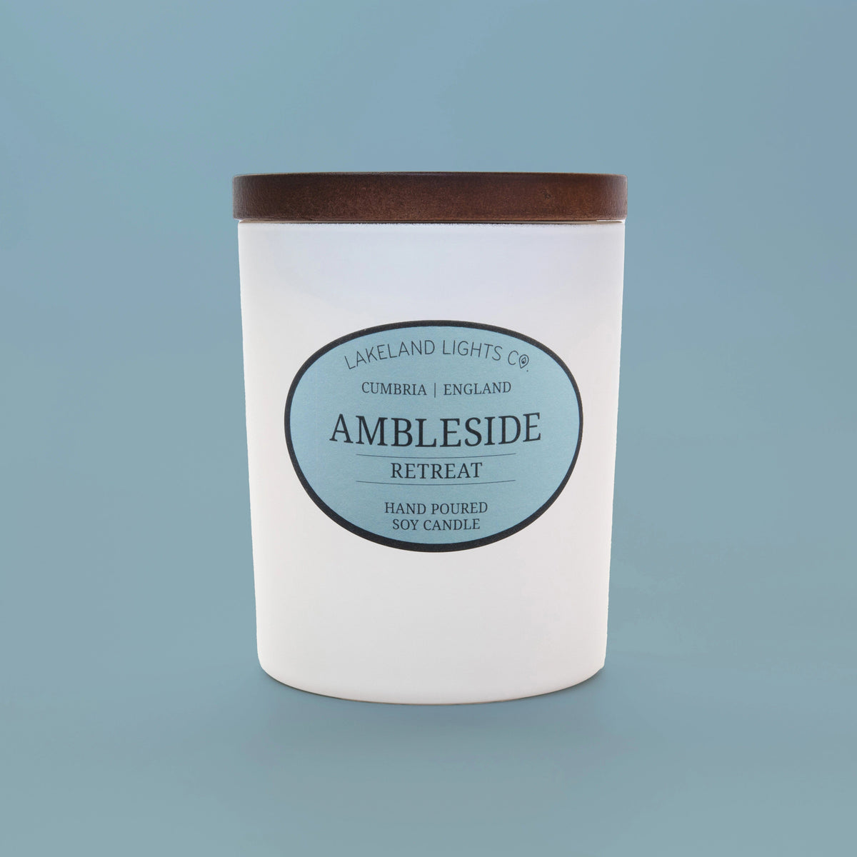 Ambleside Retreat soy candle by Lakeland Lights, featuring lavender, lemon, and jasmine scent, against a light blue background.